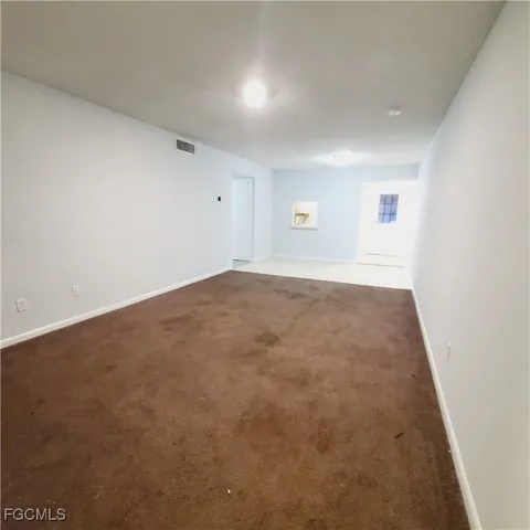 an empty room with a empty space and windows