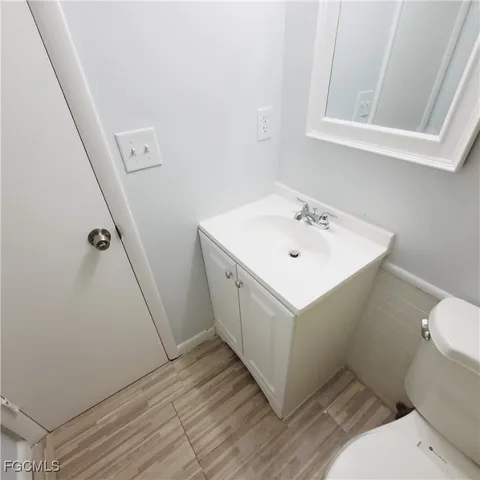 a bathroom with a sink toilet and vanity