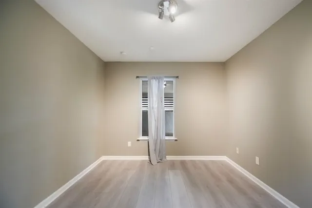 an empty room with a empty space and a window