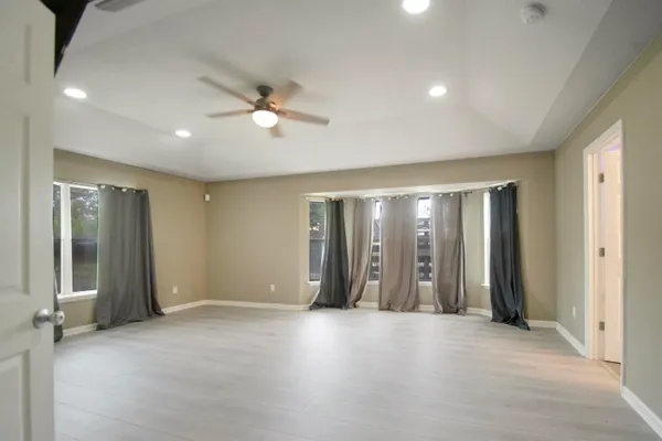 an empty room with closet and windows