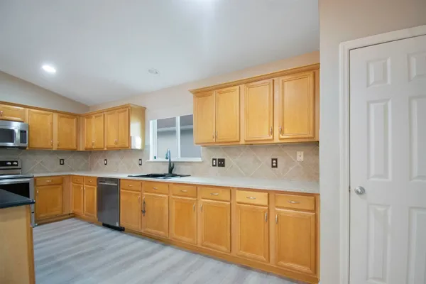 a kitchen with wooden cabinets and sink