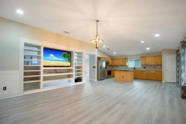a view of a room with wooden cabinet and windows