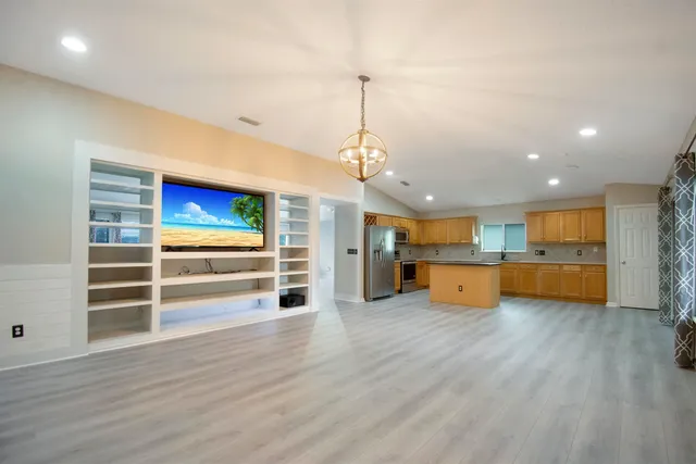 a view of a room with wooden cabinet and windows