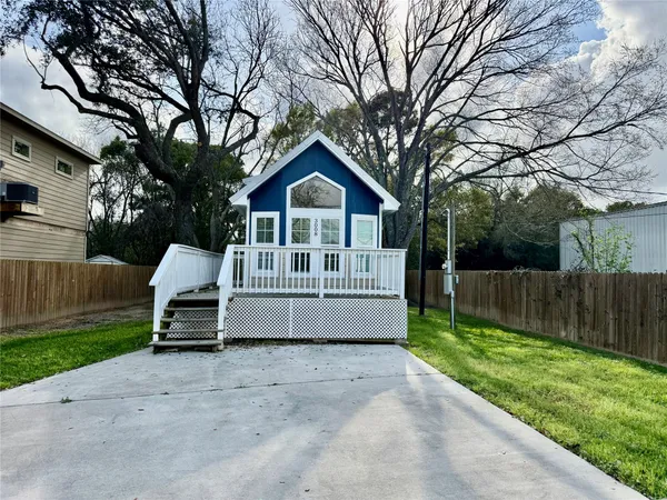 a view of a house with a yard and sitting area