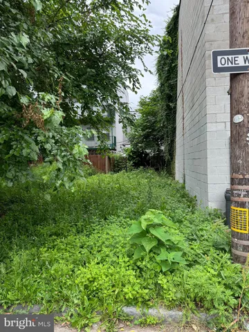 a backyard of a house with lots of green space and fountain