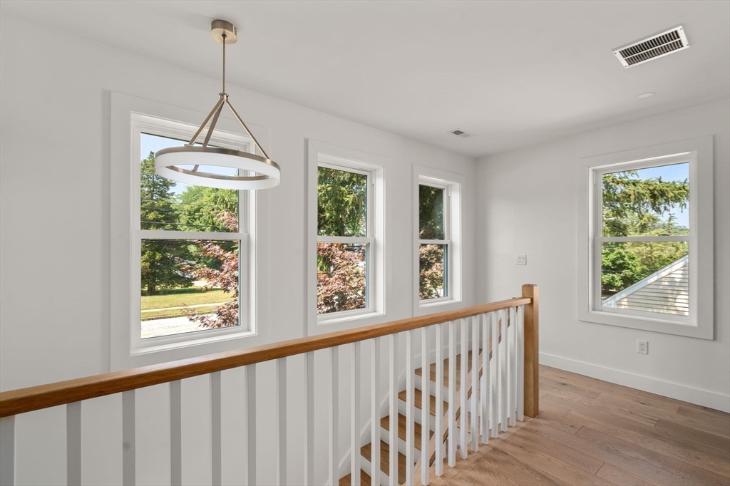 128 Webster Street Needham, MA 02494 - Photo 12 of 30 a view of a room with wooden floor windows and a chandelier
