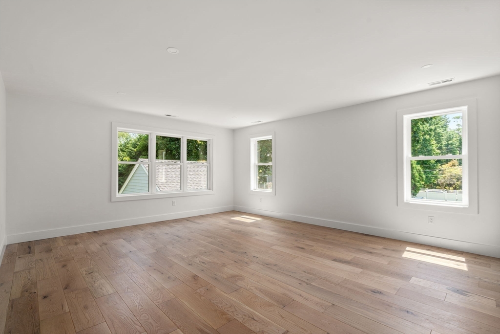 128 Webster Street Needham, MA 02494 - Photo 13 of 30 an empty room with wooden floor and windows