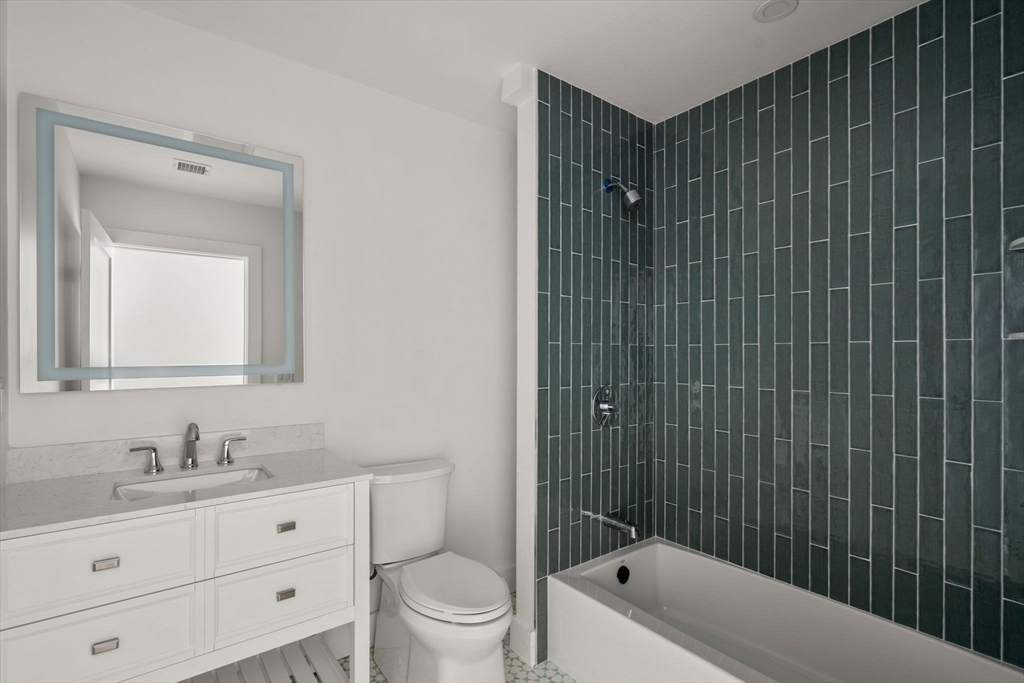 128 Webster Street Needham, MA 02494 - Photo 16 of 30 a bathroom with a shower a toilet a sink and mirror