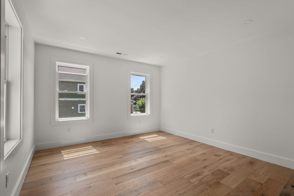 128 Webster Street Needham, MA 02494 - Photo 17 of 30 an empty room with wooden floor and windows