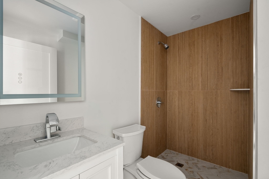 128 Webster Street Needham, MA 02494 - Photo 18 of 30 a bathroom with a granite countertop sink vanity mirror and toilet