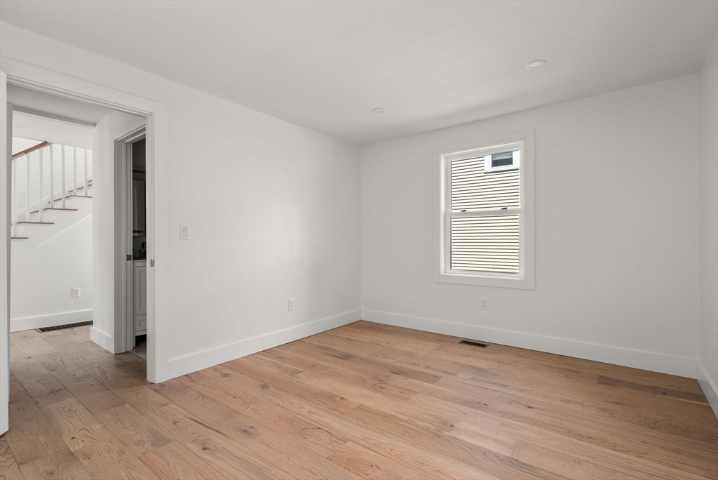 128 Webster Street Needham, MA 02494 - Photo 19 of 30 an empty room with wooden floor and windows