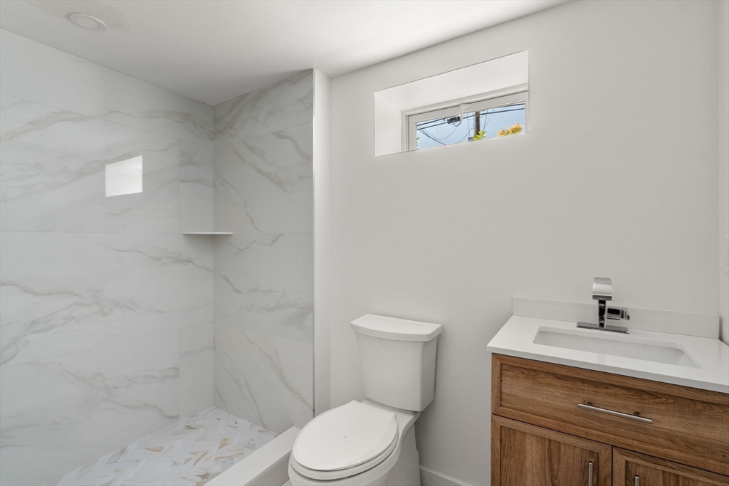 128 Webster Street Needham, MA 02494 - Photo 22 of 30 a bathroom with a toilet a sink and shower