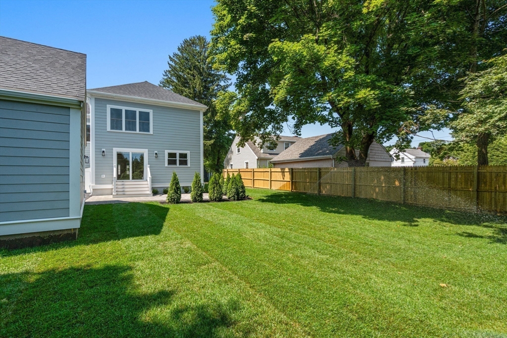 128 Webster Street Needham, MA 02494 - Photo 24 of 30 a view of a house with backyard and a tree