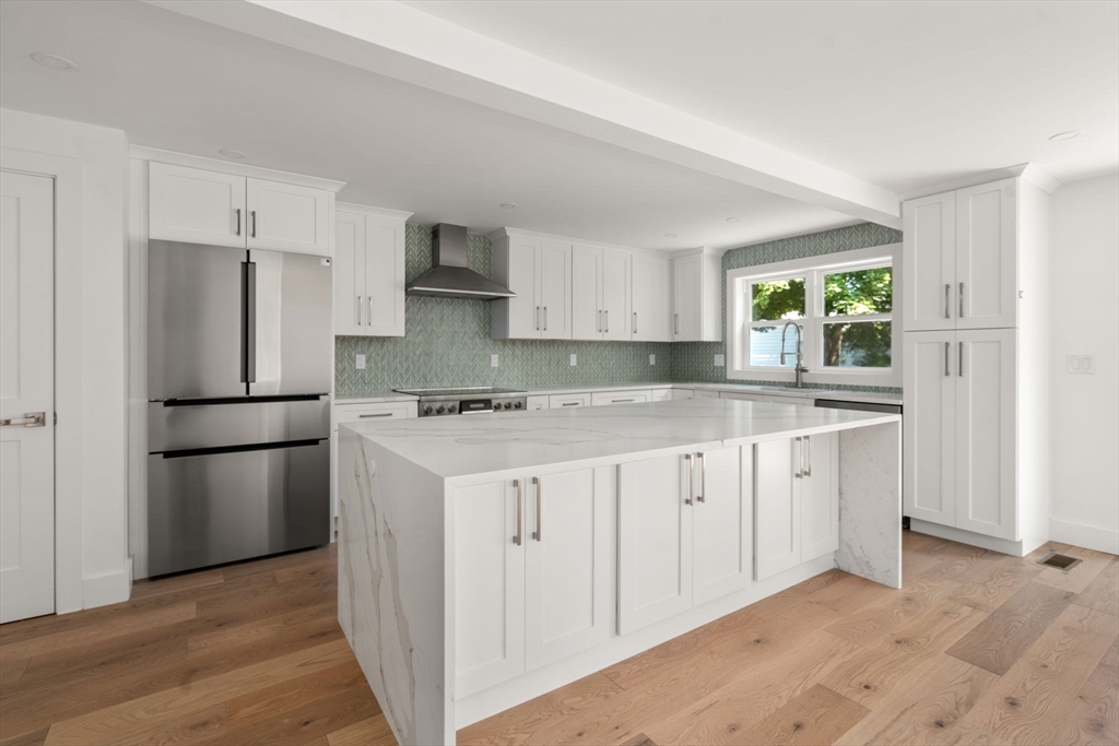 128 Webster Street Needham, MA 02494 - Photo 8 of 30 a kitchen with a refrigerator a stove a sink and a window