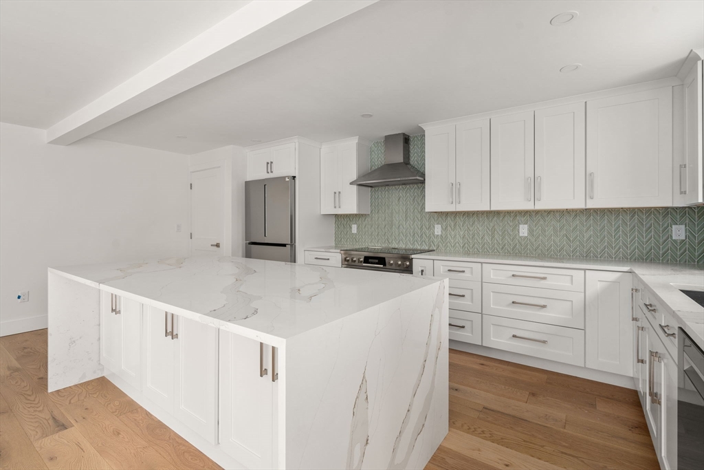 128 Webster Street Needham, MA 02494 - Photo 9 of 30 a kitchen with white cabinets and white appliances