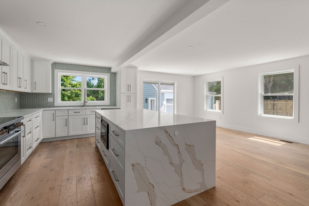 128 Webster Street Needham, MA 02494 - Photo 10 of 30 a kitchen with granite countertop a stove and a sink