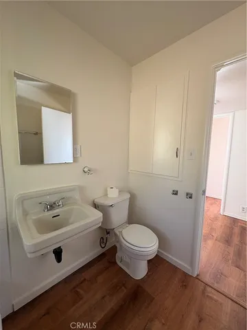 a bathroom with a sink toilet and mirror