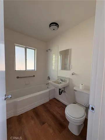 a bathroom with a toilet a sink and bathtub