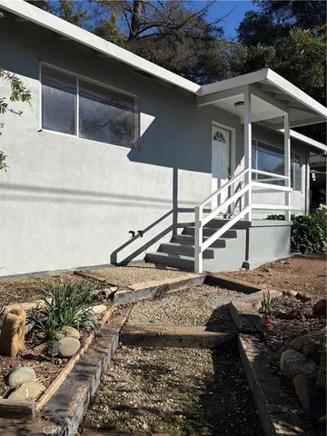 a view of a house with a wooden fence