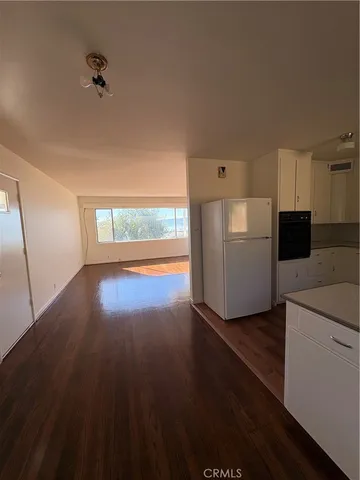 a view of kitchen with furniture and wooden floor