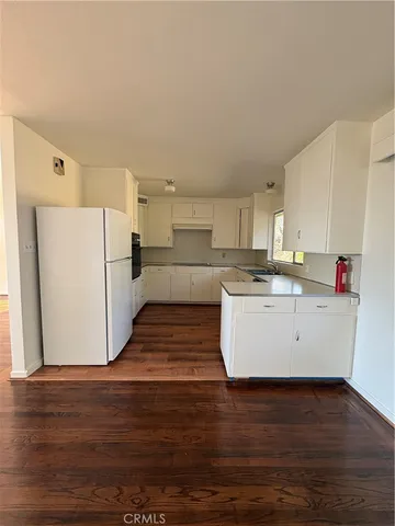 a view of kitchen with wooden floor