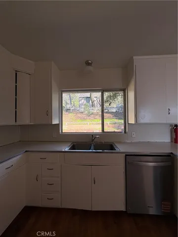 a kitchen with appliances cabinets and a sink