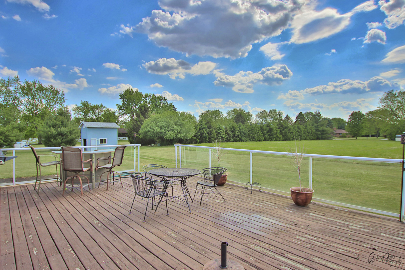 9719 Richardson Road Spring Grove, IL 60081 - Photo 20 of 26 a view of a deck with chair and table with wooden floor and fence