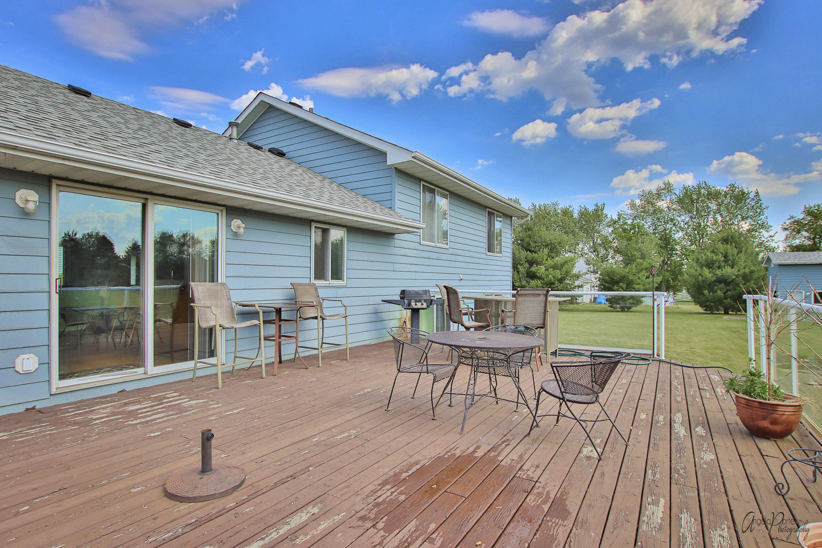 9719 Richardson Road Spring Grove, IL 60081 - Photo 21 of 26 a balcony with wooden floor table and chairs