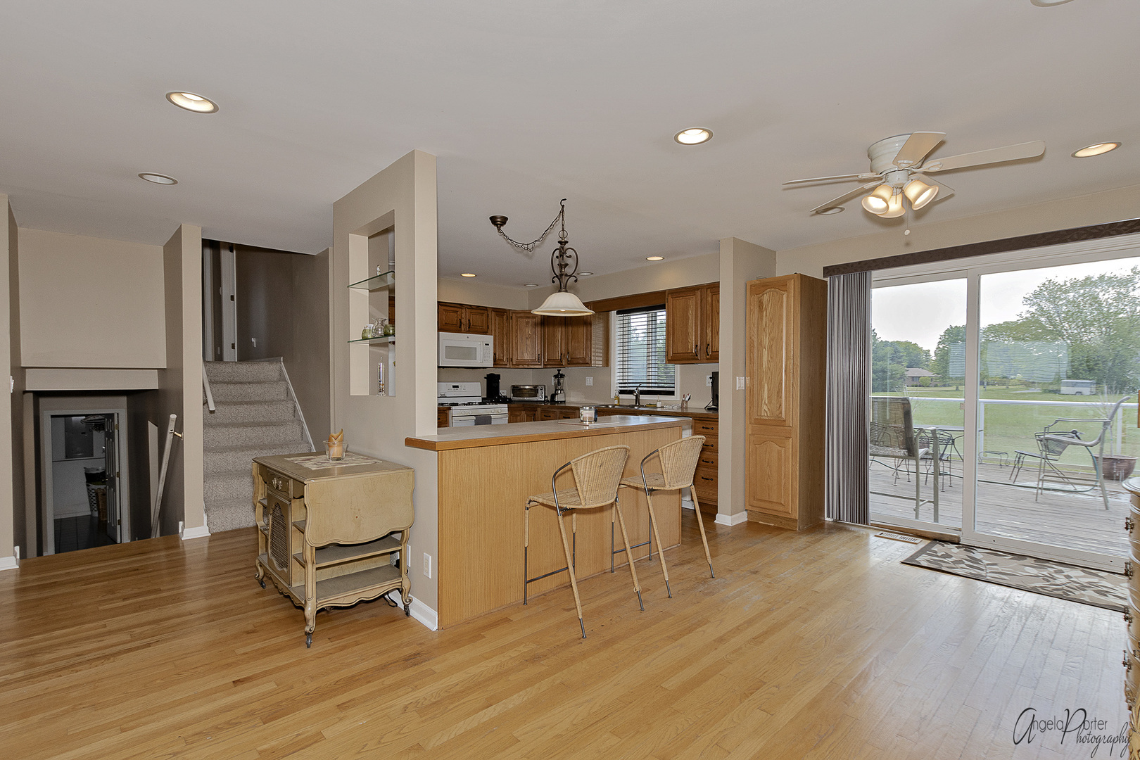 9719 Richardson Road Spring Grove, IL 60081 - Photo 6 of 26 a kitchen with stainless steel appliances kitchen island granite countertop a refrigerator a stove a sink a dining table and chairs with wooden floor