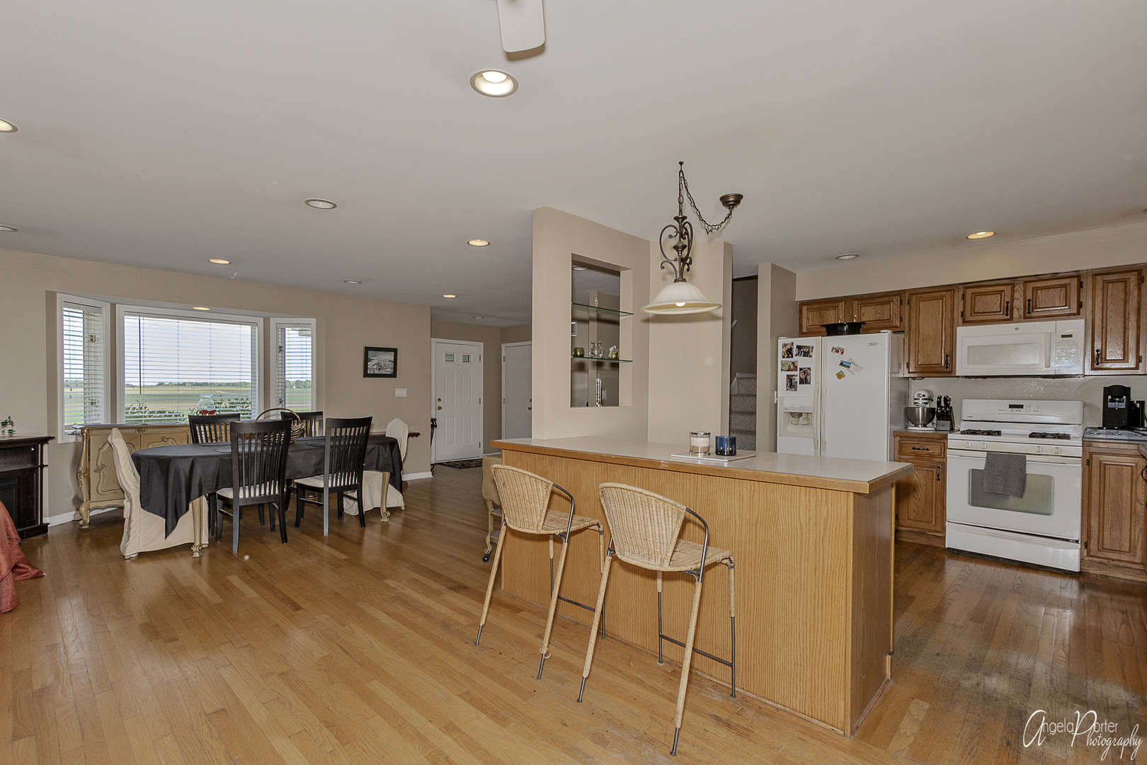 9719 Richardson Road Spring Grove, IL 60081 - Photo 7 of 26 an open kitchen with wooden floor and stainless steel appliances