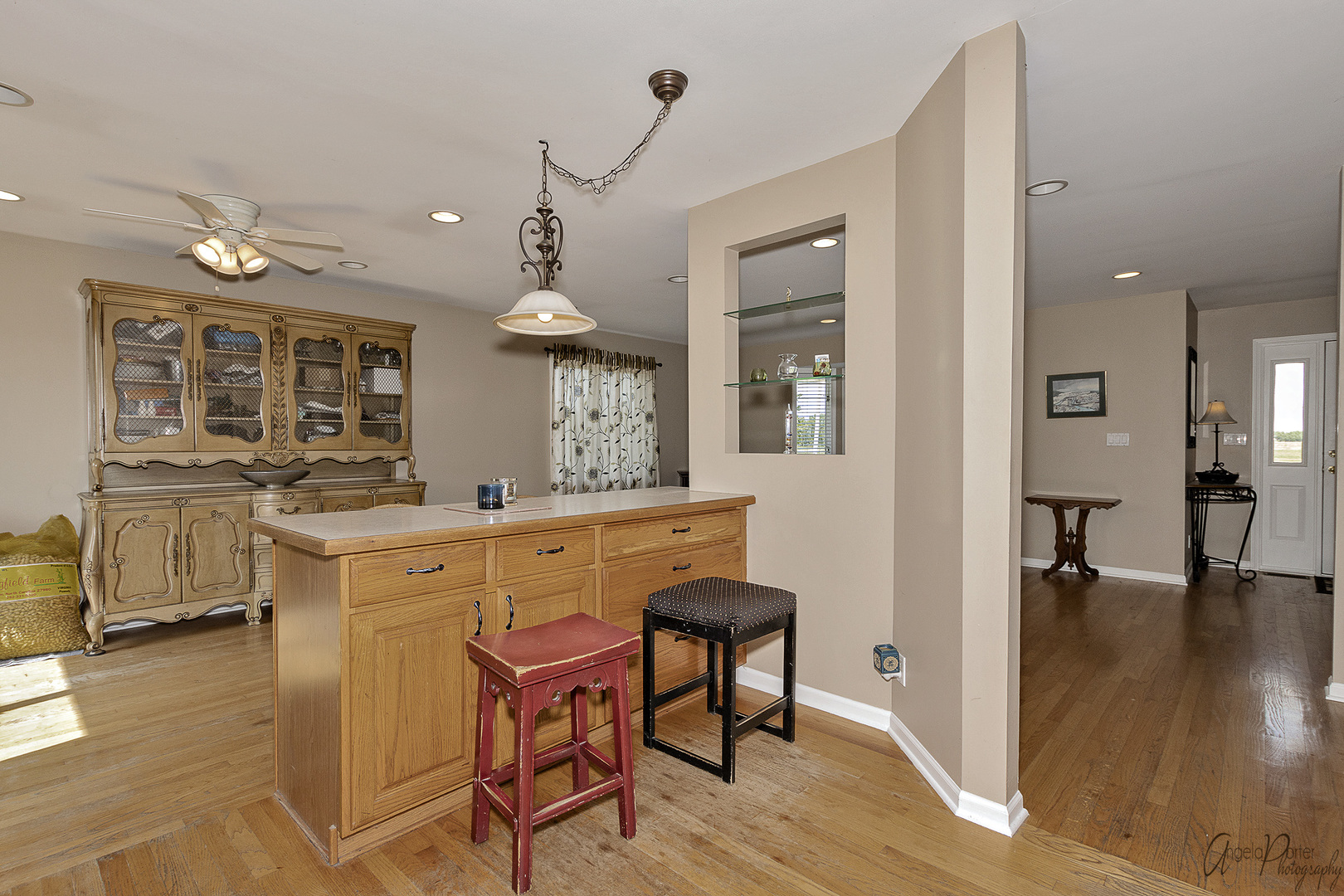 9719 Richardson Road Spring Grove, IL 60081 - Photo 10 of 26 a kitchen with stainless steel appliances kitchen island granite countertop a stove a refrigerator a dining table and chairs with wooden floor