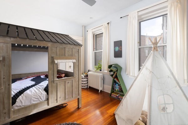 30 Powell Street, Unit 2 Brookline, MA 02446 - Photo 15 of 27 a living room with furniture and wooden floor