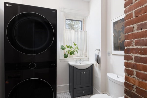 30 Powell Street, Unit 2 Brookline, MA 02446 - Photo 19 of 27 a bathroom with a toilet a sink and mirror