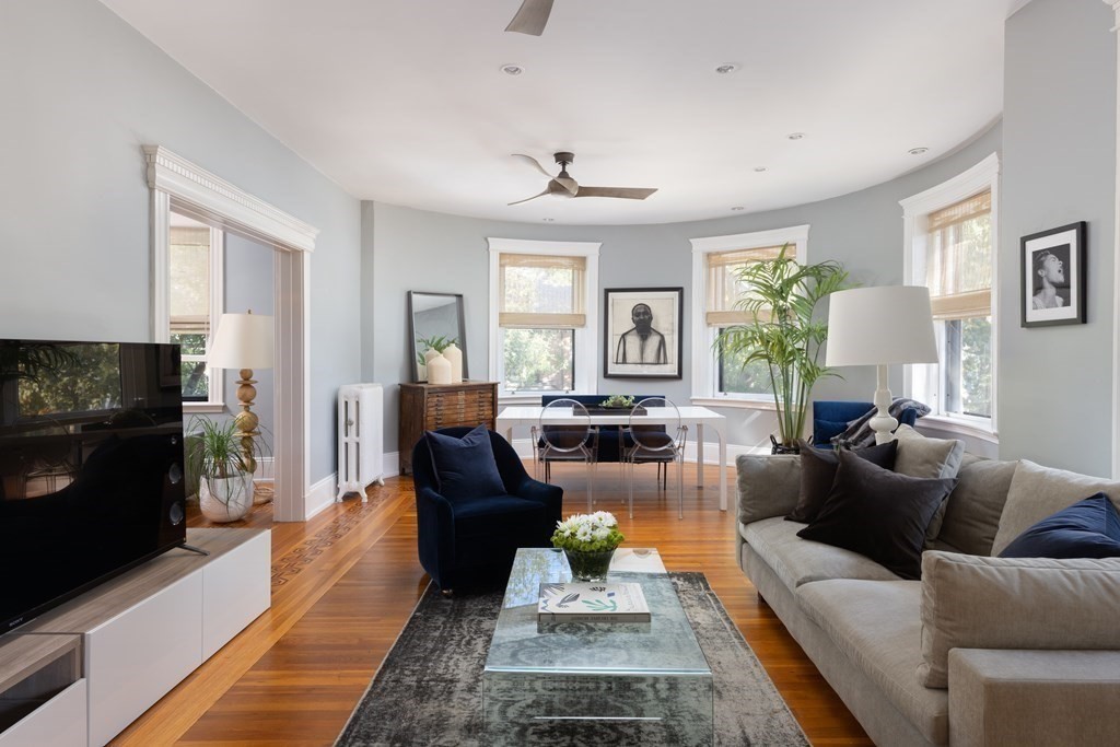 30 Powell Street, Unit 2 Brookline, MA 02446 - Photo 5 of 27 a living room with furniture a large window and a fireplace