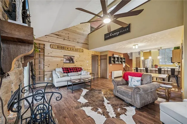 a living room with furniture and a ceiling fan