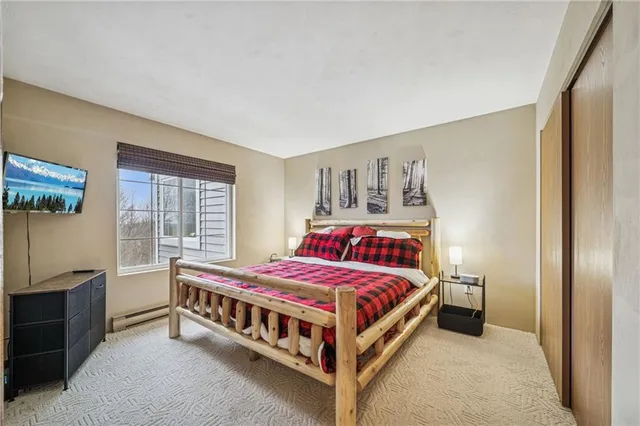 a bed room with a bed and a window