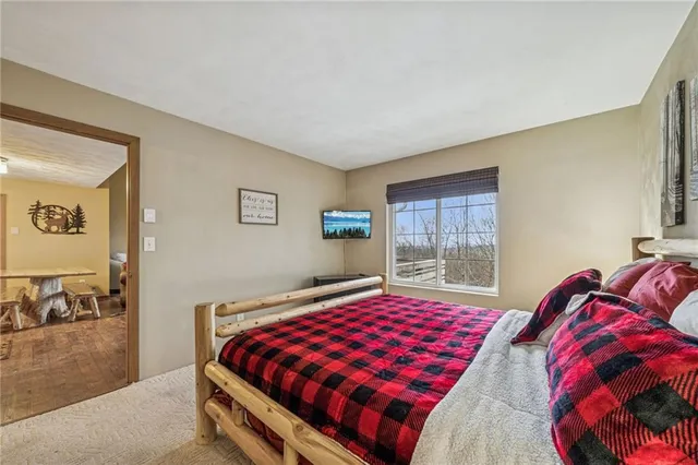 a bedroom with a large bed and a couch