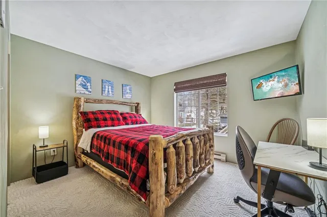 a bed room with a bed and a chair