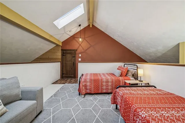 a bedroom with two beds and a couch