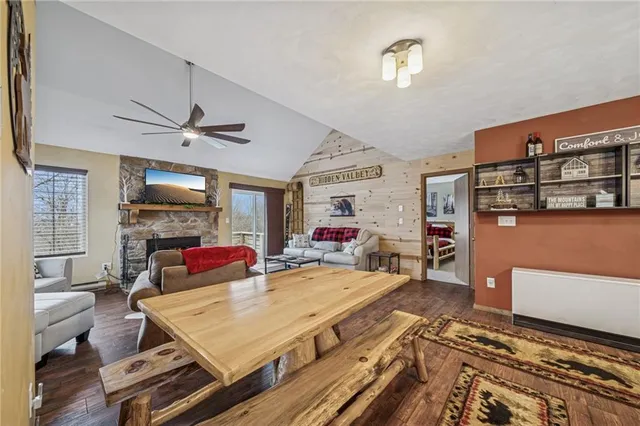 a living room with furniture flat screen tv and a fireplace