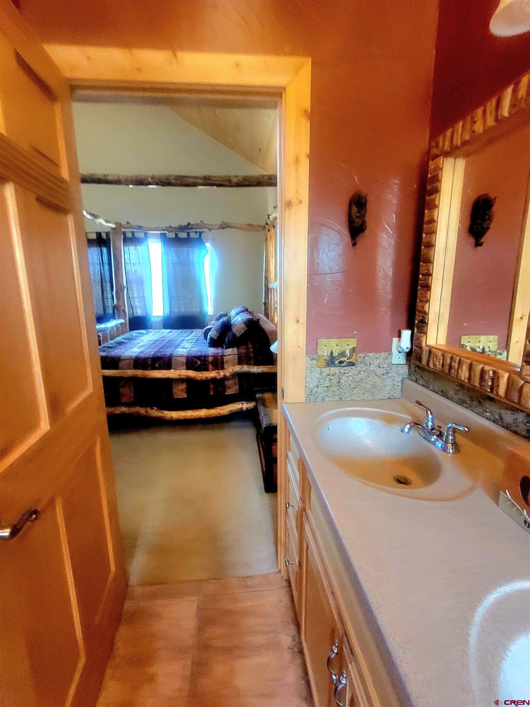 74 Owhi Road South Fork, CO 81154 - Photo 23 of 41 a bathroom with a tub a sink and mirror