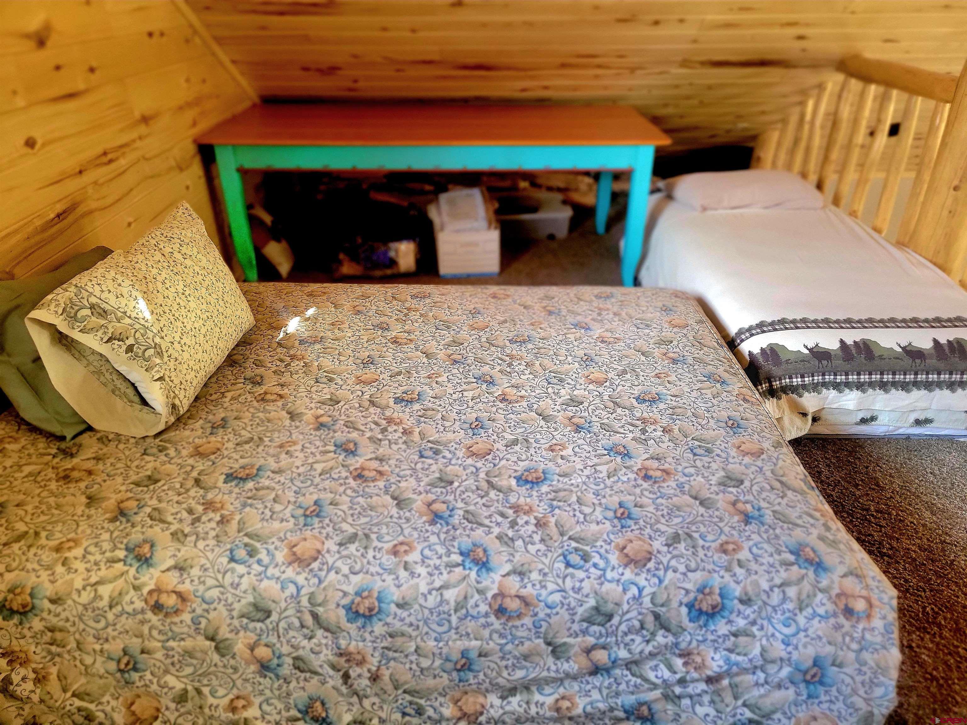 74 Owhi Road South Fork, CO 81154 - Photo 34 of 41 a bedroom with a bed and a fireplace