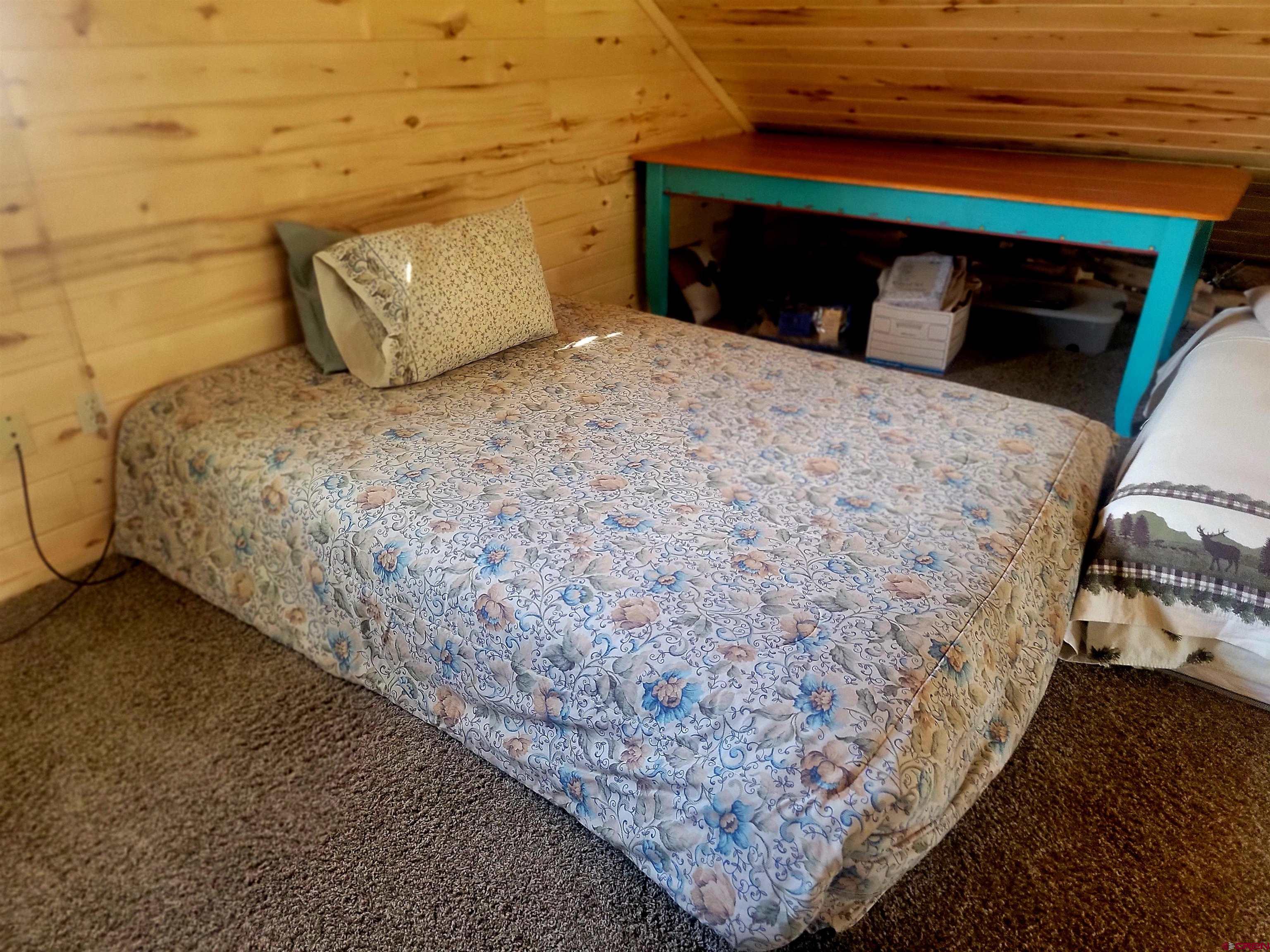 74 Owhi Road South Fork, CO 81154 - Photo 35 of 41 a bedroom with a bed and a mirror