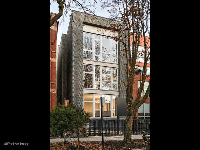 a view of a large brick building in front of a house