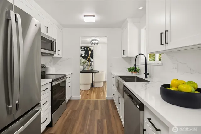 a kitchen with stainless steel appliances a sink stove and refrigerator