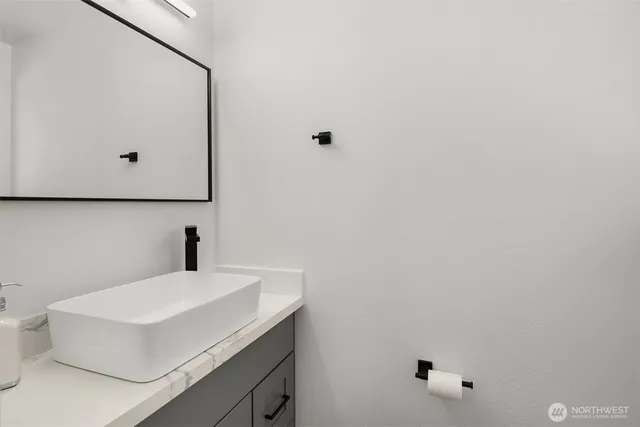 a bathroom with a sink and mirror
