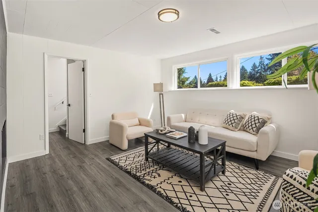 a living room with furniture and wooden floor