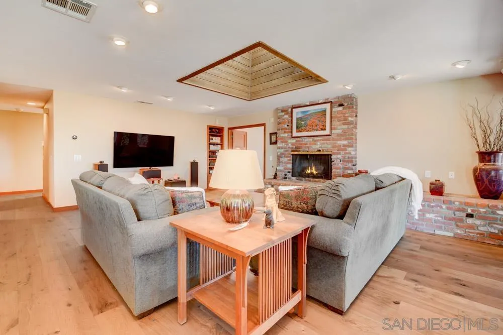 17758 Del Paso Drive Poway, CA 92064 - Photo 16 of 42 a living room with furniture fireplace and flat screen tv
