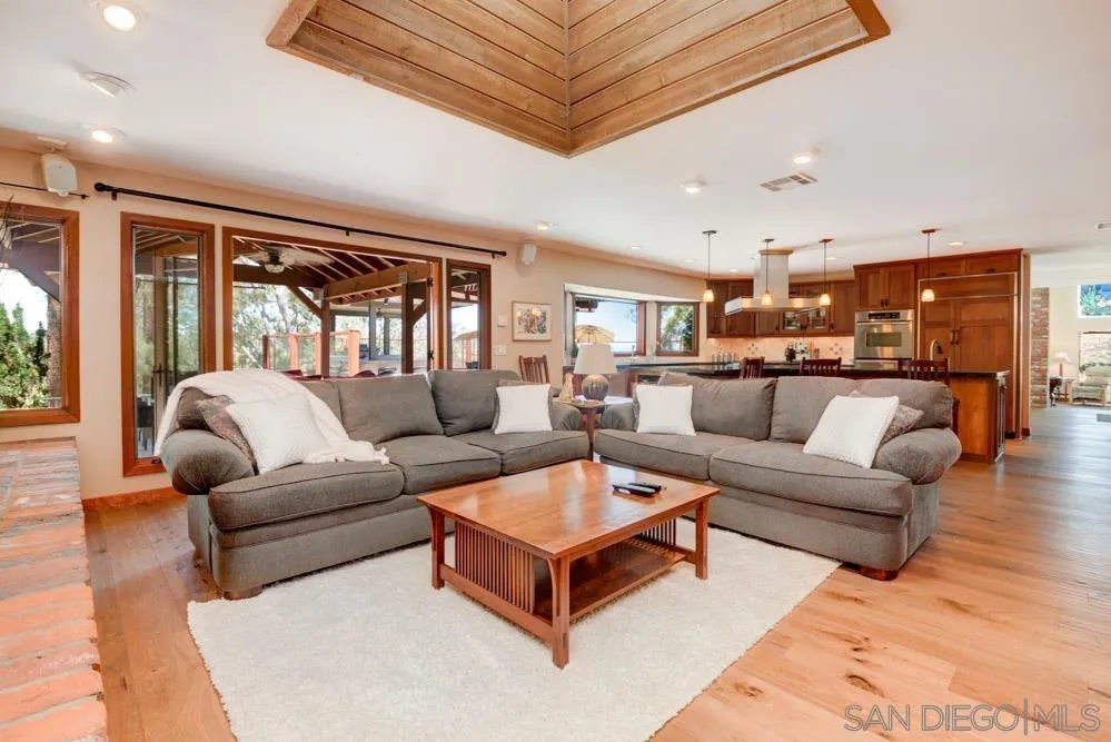 17758 Del Paso Drive Poway, CA 92064 - Photo 17 of 42 a living room with furniture a large window and a chandelier
