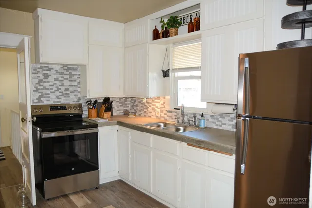 a kitchen with a sink stove and refrigerator
